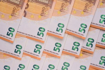Background of fifty Euro banknotes, close-up. The view from the top