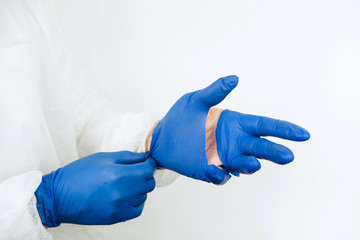 doctor's hands close-up in torn rubber gloves. torn medical gloves after a working day at the...