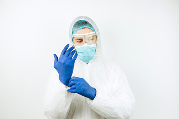 portrait of tired doctor after shift in the hospital. The doctor in protective clothing - glasses,...