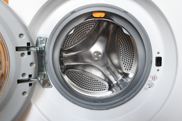 White washing machine with opened door close-up - Empty inside