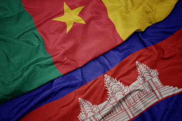 waving colorful flag of cambodia and national flag of cameroon.