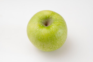One juicy green fresh apple on a white background