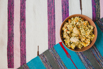 The national dish is Uzbek pilaf with chicken on bright striped mats. Flat layout