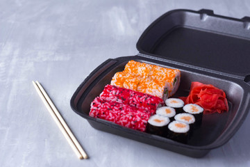 sushi delivery, home delivery in plastic and paper packaging, contactless delivery during the coronavirus epidemic