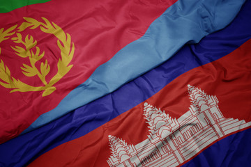 waving colorful flag of cambodia and national flag of eritrea.