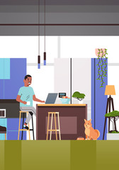 african american man freelancer using laptop working at home during coronavirus quarantine self-isolation social distancing concept modern kitchen interior vertical full length vector illustration