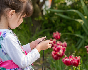 Girl photographing flowers