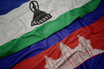 waving colorful flag of cambodia and national flag of lesotho.