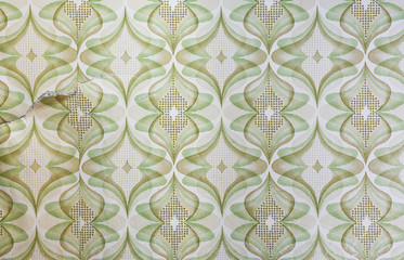 Old torn wallpaper on the wall.Old wallpaper for texture or background.