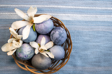 blue easter eggs with flowers in the basket