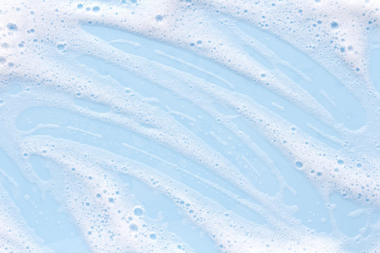 soap foam on light blue background, macro texture