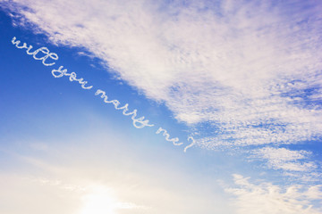 sky clouds with the question will you marry me