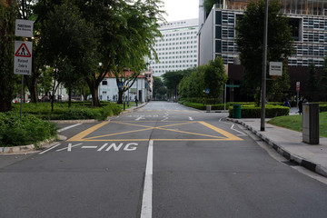 Fototapeta na wymiar Quiet Singapore street with less tourists and cars during the city lockdown called
