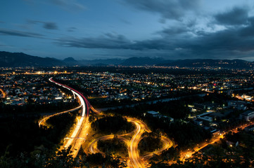 Slip road at night with view over town, long exposure, Gebhardsberg, Austria, Europe