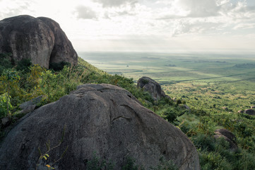 Big grey boulders at slope of Kajulu Hills with view of fields, Kisumu, Kenya, Africa