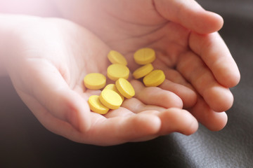 Yellow tablets in children's hands
