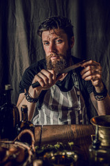chef man cooking in rustic kitchen