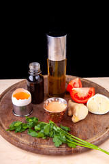 sauce and ingredients included in it on a wooden board
