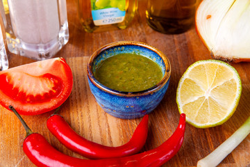 sauce and ingredients included in it on a wooden board