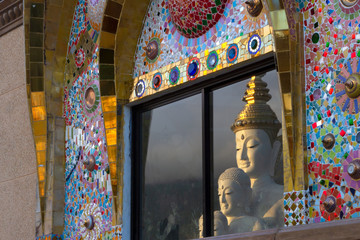 Buddha reflected in windows of temple. at Wat Pha Sorn Kaew in Kao Kho,Petchabun, Thailand