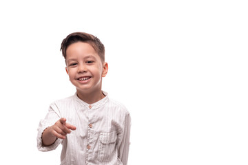 Shot of a little smiling boy pointing at something, isolated