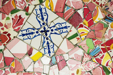 Broken glass mosaic tile, decoration in Park Guell, Barcelona, Spain. Pottery art Gaudi