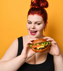 Happy overweight fat woman happy hold big burger cheeseburger sandwich. Girl on diet dieting. Healthy eating  fast food concept
