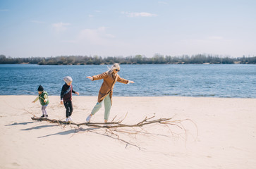 Happy family of four having fun by the river. Happy full-fledged family.