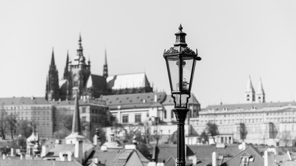 Fototapeta na wymiar Vintage street lamp on Charles Bridge. Prague Castle out of focus on the background. Prague, Czech Republic