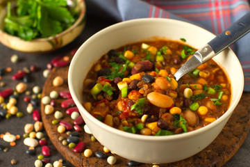 
Cooked mixed legumes beans lentils stew with tomatoes , vegan comfort food