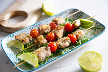 BBQ pork with cherry tomatoes and lime