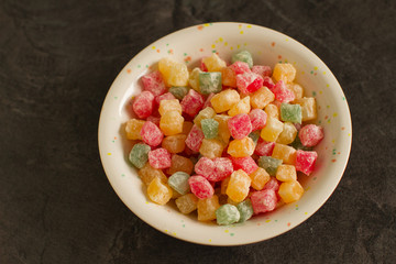 
Heap of colorful Turkish sweets delight in small colorful pieces on dark