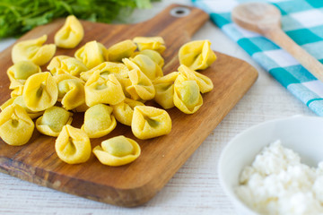 
Fresh spinach and ricotta tortellini on a rustic table