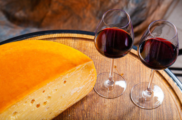 Cheese of elite variety sliced on a wooden board