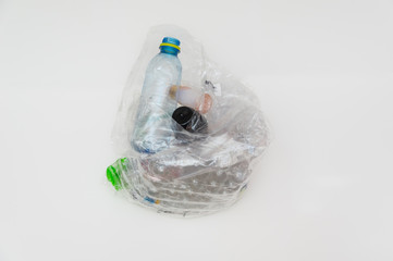 Sorting (segregating) household waste at home. Plastic (bottles, packaging) in transparent bag on...