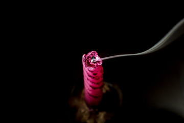 Smoke from an extinct candle on a black background