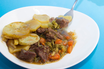 Lancashire hotpot.  is a stew originating from Lancashire in the North West of England. It consists of lamb or mutton and onion, topped with sliced potatoes and baked in a heavy pot on a low heat.