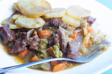 Lancashire hotpot.  is a stew originating from Lancashire in the North West of England. It consists of lamb or mutton and onion, topped with sliced potatoes and baked in a heavy pot on a low heat.