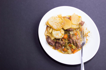 Lancashire hotpot.  is a stew originating from Lancashire in the North West of England. It consists of lamb or mutton and onion, topped with sliced potatoes and baked in a heavy pot on a low heat.