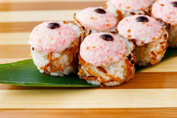 Maki Sushi Rolls set on wooden bamboo board. Japanese traditional Cuisine. White background.