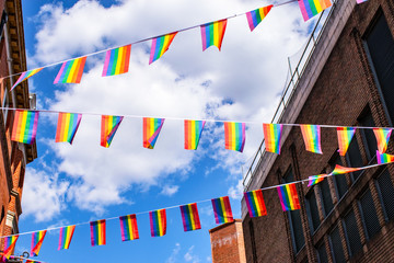 Pride flags against blue sky in Chinatown, London, UK