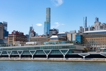 Fototapeta na wymiar Upper East Side New York City Skyline along the East River with a Blue Sky