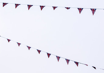 Union Jack bunting against grey sky, London, UK.