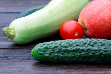 Vegetables and fruits. Tomatoes and cucumbers, apples and squash on a wooden table. Green pepper. Organic vegetables.