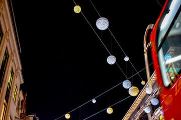 Festive lights and iconic red bus on Oxford Street, London, UK