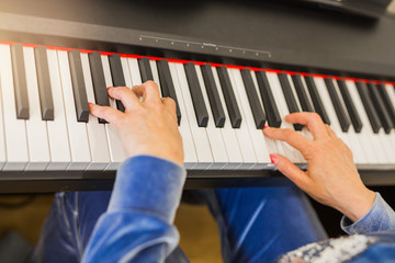 woman playing an electronic synthesizer