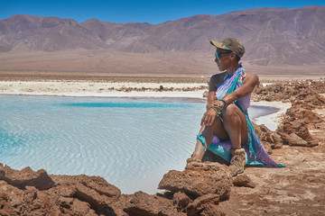 Women contemplating the views at Hidden Lagoons of Baltinache. San Pedro de Atacama, Antofagasta - Chile. Desert. Andes Range.