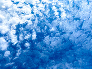 Fototapeta na wymiar Texture of clouds on blue sky illuminated by sunlight. Blue sky white clouds ,Abstract nature ,Textured pattern background ,gradient.
