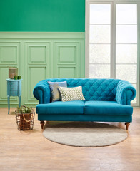 Green classic wall background, blue sofa pillow and working table background.
