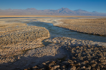 Eroded soil and view of the landscape at Chaxa Lagoon & Flamingos National Reserve Conaf. an Pedro de Atacama, Antofagasta - Chile. Desert. Andes Range.